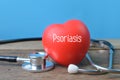 Stethoscope and red hart shape with text Psoriasis Royalty Free Stock Photo