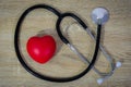 Stethoscope and red heart on wooden table Royalty Free Stock Photo