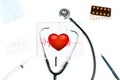 Stethoscope and red heart. Doctor table with medical items Royalty Free Stock Photo