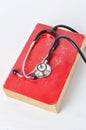 Stethoscope on red old book Royalty Free Stock Photo