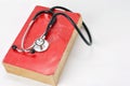 Stethoscope on red old book Royalty Free Stock Photo