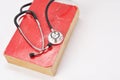 Stethoscope on red old book Royalty Free Stock Photo