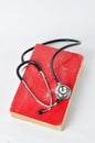 Stethoscope on red old book Royalty Free Stock Photo