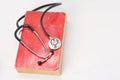 Stethoscope on red old book Royalty Free Stock Photo