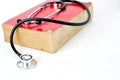 Stethoscope on red old book Royalty Free Stock Photo