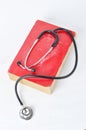 Stethoscope on red old book Royalty Free Stock Photo