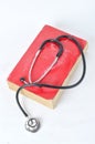 Stethoscope on red old book Royalty Free Stock Photo