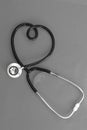 Stethoscope in the shape of heart on black and white background Royalty Free Stock Photo