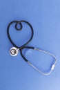 Stethoscope in the shape of heart on blue background Royalty Free Stock Photo