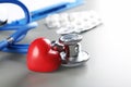 Stethoscope and small red heart on table Royalty Free Stock Photo