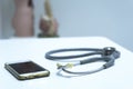 Stethoscope and smartphone on the doctor table Royalty Free Stock Photo