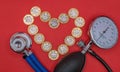 Stethoscope and sphygmomanometer with a heart made of pound coins