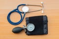 Stethoscope and sphygmomanometer on wooden texture background Royalty Free Stock Photo