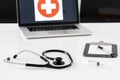 Stethoscope, syringe and mask on doctor desk