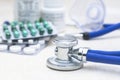 Stethoscope on the table, blurred capsules, medicines, medicine bottles and medical supplies Royalty Free Stock Photo