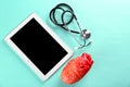 Stethoscope, tablet and model of heart