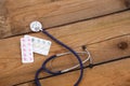 Stethoscope and tablets isolated on wooden background Royalty Free Stock Photo