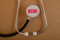 Stethoscope with text ACNE. Acne is a common skin condition that occurs when hair follicles become clogged with oil, dead skin