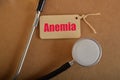 Stethoscope with text ANEMIA. Anemia is a condition characterized by a decrease in the number of red blood cells or a decrease in Royalty Free Stock Photo