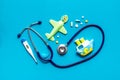 Stethoscope, toys and pills - baby flu and cold concept - on blue background top view