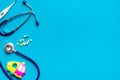 Stethoscope, toys and pills - baby flu and cold concept - on blue background top view copy space