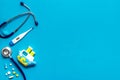 Stethoscope, toys and pills - baby flu and cold concept - on blue background top view copy space