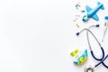 Stethoscope, toys and pills - baby flu and cold concept - on white background top view copy space