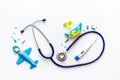 Stethoscope, toys and pills - baby flu and cold concept - on white background top view