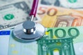 Stethoscope on US dollar and EURO banknotes, Finance, Account, Statistics, Analytic research data and Business company  medical Royalty Free Stock Photo