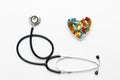 Stethoscope on white background with pills in shape of heart Royalty Free Stock Photo