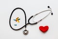 Stethoscope on white background with plush heart top view Royalty Free Stock Photo