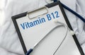 Stethoscope and white card with Vitamin B12 text on white background. Medical concept. Royalty Free Stock Photo