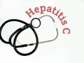 Stethoscope with the word hepatitis C on white background Royalty Free Stock Photo