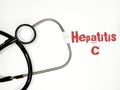 Stethoscope with the word hepatitis c on white background Royalty Free Stock Photo