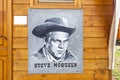 Steve McQueen portrait hanging on wooden wall