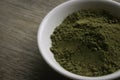 Stevia powder in white plate on wooden background