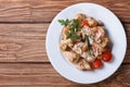 Stew chicken with mushrooms on a white plate top view Royalty Free Stock Photo