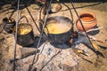 Stew in iron pot on a campfire, homemade food