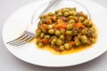 Stew with peas, carrots, onions and tomato sauce
