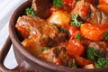 Stew in tomato sauce with vegetables and herbs macro. top view Royalty Free Stock Photo