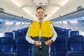 Steward securing straps of a life vest around his waist