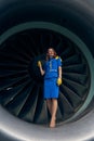 Stewardess with a faraway look posing for the camera