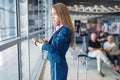 Stewardess legs and suitcase in airport hall