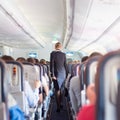 Stewardess and passengers on commercial airplane. Royalty Free Stock Photo