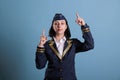 Stewardess pointing up with index fingers Royalty Free Stock Photo