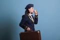 Stewardess in professional airline uniform carrying baggage