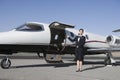 Stewardess Standing By Airplane At Airfield