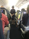 Stewardess greeting passengers on a Delta airlines flight.