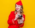 Stewardess wearing in red uniform with photo camera