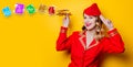 Stewardess wearing in red uniform with wooden airplane.